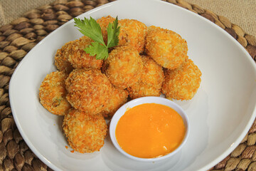A plate of katsu meatballs with cheese sauce. Delicious restaurant food