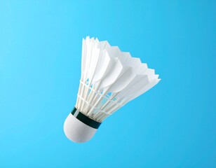 Badminton shuttlecock floating on blue background