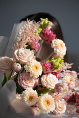 Beautiful floral arrangement with pink and white blooms and hidden female figure