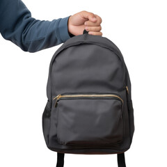 A person holding a gray backpack against a blank background. The backpack features a front pocket with a zipper and shoulder straps, ideal for students, travelers or anyone needing a bag