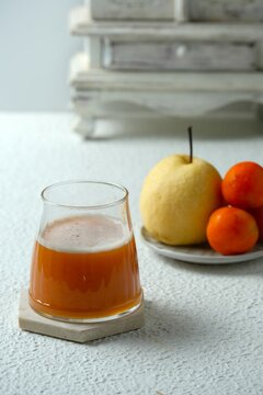 A glass of fresh and healthy juice on white background, made from pear and tomatoes. Juice for recipe, menu book aor food wallpaper. Jus sayur dan buah