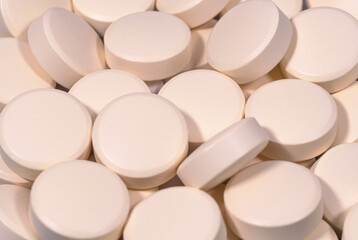 Medical pills creamy pink close up