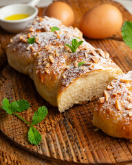 Brioche braid with toasted almonds and powdered sugar. A traditional French pastry recipe.