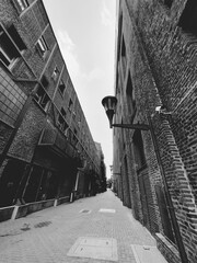industrial zone with focus on old light pole on street in city of Rosario, Argentina and black and white photo