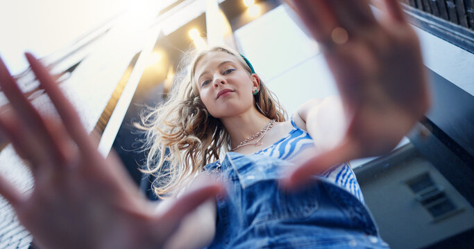Below, hand frame and portrait of girl in city with confidence for style, trendy or outfit. Low angle, perspective and selfie of person in town for fashion, aesthetic and picture for photography