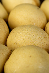 ripe pear with a yellow colour on the table, sweet fresh white pear , side view