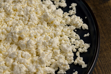 cottage cheese from milk in the form of lumps of white color, lumps of freshly made fermented milk