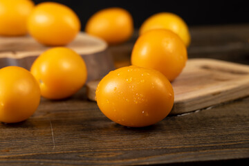 yellow tomatoes on the table, freshly washed tomatoes with drops of water on them