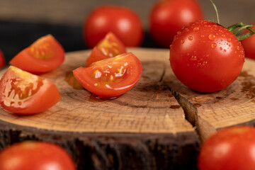 several ripe red tomatoes during slicing for cooking