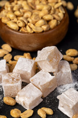 Turkish delight with peanuts, scattered oriental sweets Turkish delight with peanuts on a board