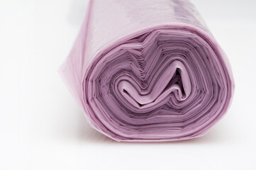 Roll of plastic garbage bags on white background