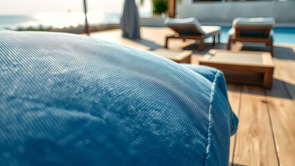 Beachfront living room with a blue couch and pool by a wooden deck