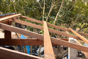 Wood structure frame under construction or installation for roof building consist of member i.e. purlins, rafter, stud beam, king post and column for suport roof sheet with slope.