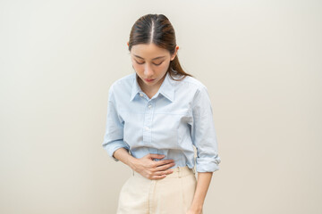 Flatulence asian young woman intolerance hand in stomach ache, suffer from food poisoning,...