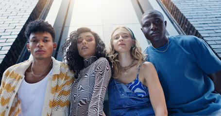 Below, fashion and portrait of friends in city with confidence for style, trendy clothes and outfit. Low angle, gen z and men and women in urban town for perspective, aesthetic and photography