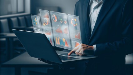 Man in suit using laptop with holographic charts and data visualizations hovering above