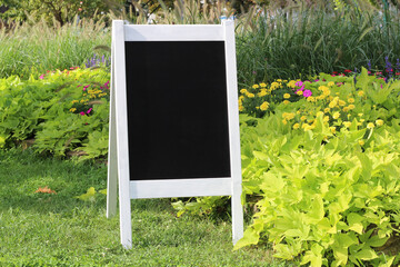 Vintage Black Chalkboard, blank welcome sign Mockup with white wooden frame, outdoors. Vintage wedding greeting sign mock up template.