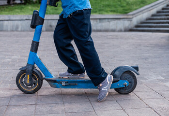 A woman and a teenager interact with an electric scooter using a smartphone — urban mobility...