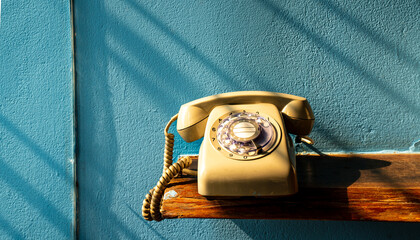 Vintage telephone, classic corded and rotary desk phone, commonly used during the 90s. Users need to roll specific numbers to dial. This soon to be outdated, replaced by personal mobile phone