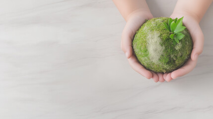 Hands gently hold a moss-covered globe with fresh leaves, symbolizing protection, care, and environmental awareness.
