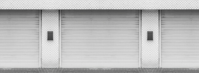Closed steel shutter doors of warehouse, storage or storefront for metal door background banner...