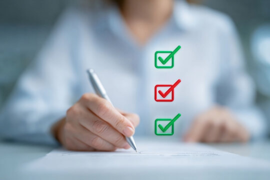 Check marks on list items done and not done with a hand holding a pen on blurred background. Business, paperwork and checklist concept. Close-up shot for poster, visual, design