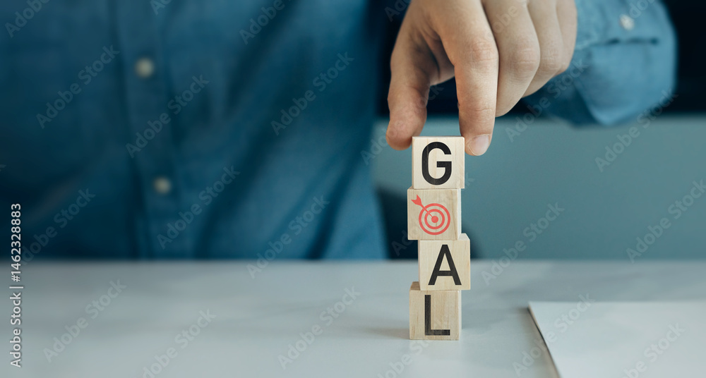 Poster close-up hands showing virtual target icons on wooden cube.business plan strategy and development .a