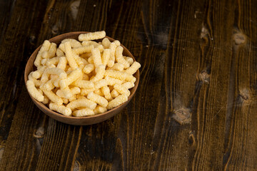 corn sticks close up, a large number of corn sticks for eating or making breakfast with milk, corn sticks in a wooden bowl