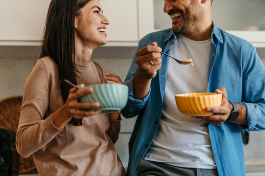 Happy couple enjoying breakfast together in modern kitchen