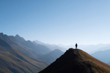 Naklejka premium lone hiker stands on mountain peak silhouetted against vast expanse of open sky that creates ample copy space