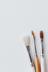 Fototapeta premium serene minimalistic image featuring paintbrushes against pristine white canvas