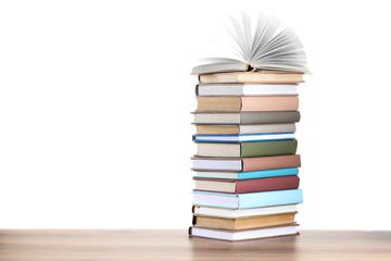 Stack of old books on wooden table against white background