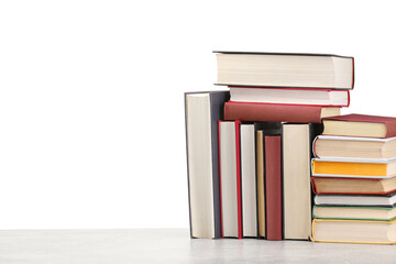 Old books on light grey table against white background