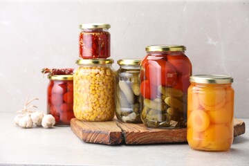 Many jars with different pickled products on light table