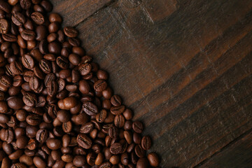 Aromatic coffee beans on wooden table, top view. Space for text