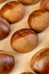 preparation by cutting the shells of edible chestnut nuts for baking, closeup