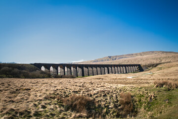 A spring HDR landscape image of the iconic Ribblehead Viaduct, aka Batty Moss Viaduct, in the Yorkshire Dales National Park, England