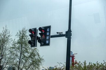Traffic signal in China, two red traffic lights, Right Turn Control text in chinese and a...