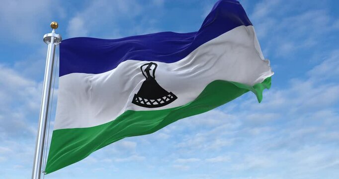 Lesotho flag with flagpole waving in wind, rolling clouds background looping, 4K video (Perfect Loop)