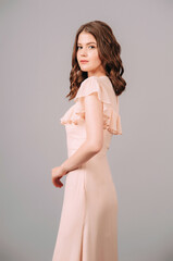 Short sleeve evening dress with ruffle neckline in ivory. Gorgeous sexy lady with curly hairstyle....