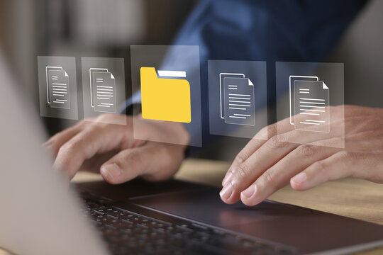 Digital data storage technology document file concept. Businessman use laptop with file document icon on virtual screen for online documentation database.