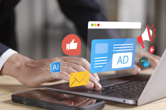 Online advertising concept. Businessman use laptop with online advertising on virtual screen for programmatic Advertising cross targeting.