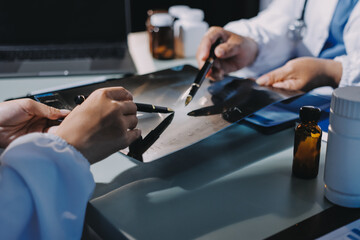 Male and female doctors are having a meeting in a hospital room.