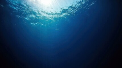 Underwater view of deep blue water with sunlight.