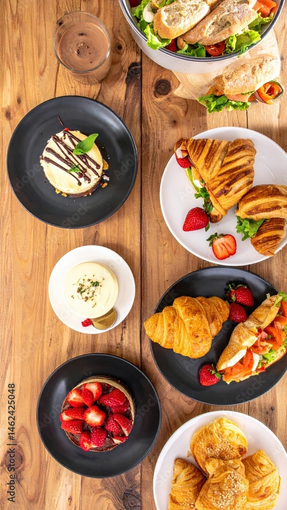 Poster a beautifully set dining table adorned with an array of colorful plates filled with delicious food, 