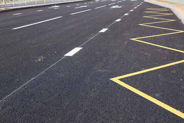Bus stop sign with yellow paint on asphalt