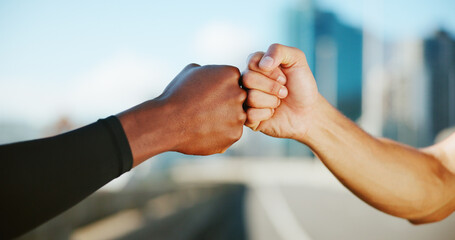Fitness, people and hands in city for fist bump, team support and wellness goal. Solidarity, man...