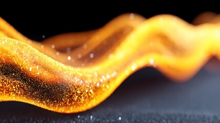 Vibrant abstract wave with sparkling details in gold and orange hues.