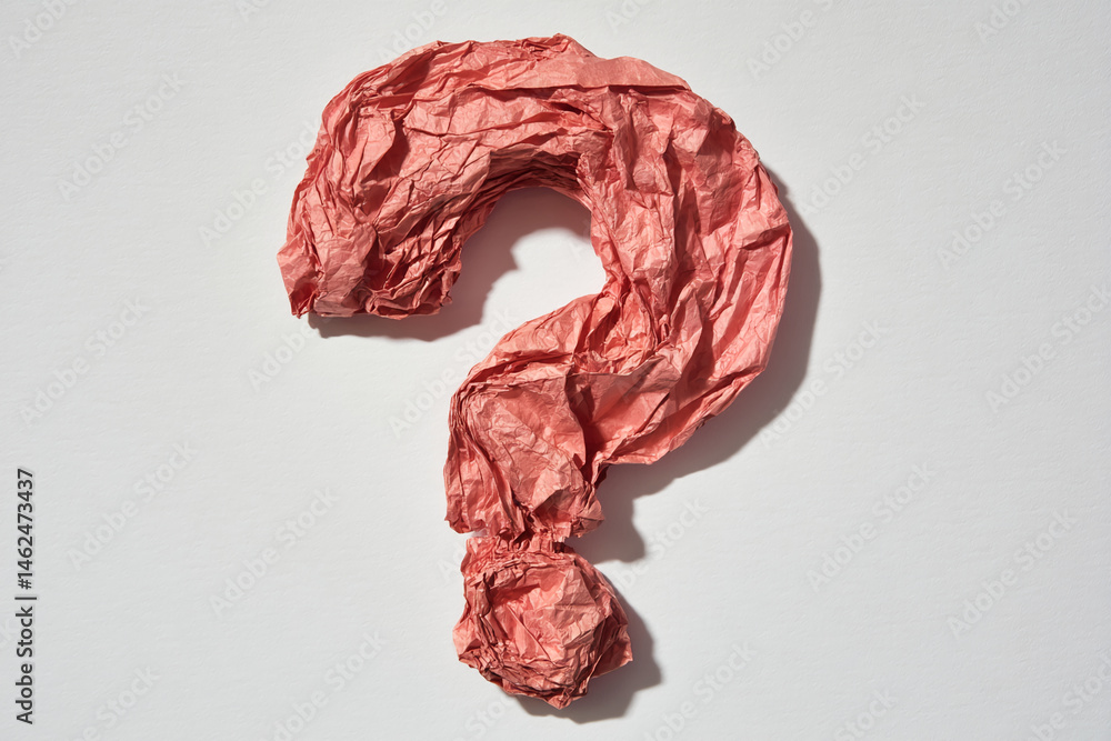 Poster red crumpled paper shaped as question mark on white background, symbolizing uncertainty, inquiry, or