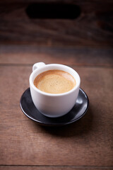 Cup of coffee on wooden background. Soft focus. Copy space